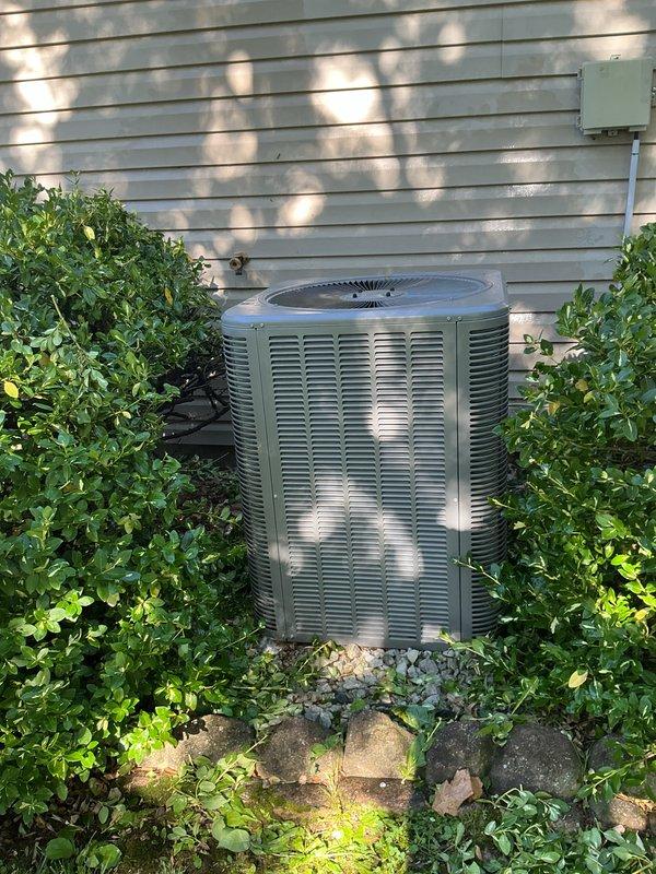 Completed comprehensive cooling season tune-up on 7-year-old residential air conditioning system with outdoor condensing unit located in backyard and air handler in utility room. Performed full system inspection including electrical connections, refrigerant levels, condenser coil cleaning, blower assembly evaluation, and control circuit testing. All components found operating within manufacturer specifications; system cleared vegetation encroachment around outdoor unit to ensure proper airflow and documented equipment condition with photographic records.