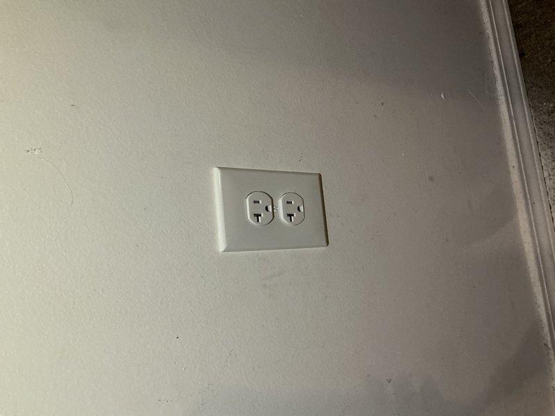 Completed electrical fixture installation including installation of new electrical outlet with standard duplex receptacle and cover plate on interior wall. Installed exterior electrical meter enclosure with digital electric meter, junction box, and associated conduit runs with proper mounting hardware and securing straps on building exterior siding. All components installed to code specifications with proper grounding and weatherproofing measures for exterior installations.