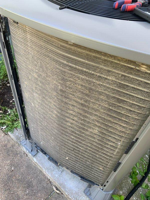 Completed comprehensive tune-up on a 2-year-old residential air conditioning unit located in the backyard. System inspection revealed heavily soiled condenser coils with significant accumulation of dirt, dust, and debris throughout the heat exchanger fins, which was thoroughly cleaned to restore optimal heat transfer efficiency. Replaced dirty air filter with fresh media to ensure proper airflow and system performance.