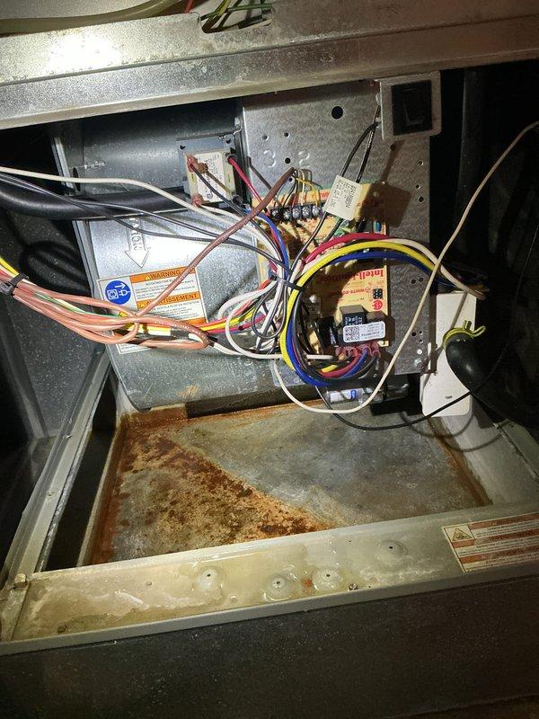 Completed comprehensive tune-up and cooling system maintenance on two residential air conditioning units located at ground level and basement. Performed standard U10 cooling protocol including inspection of electrical components, wiring harnesses, blower motor assemblies, and control boards on both systems. Noted significant rust and corrosion present in condensate drain pan of one unit, indicating ongoing moisture exposure that will require monitoring. Inspected and evaluated air filtration systems for both units to ensure proper airflow and system efficiency.