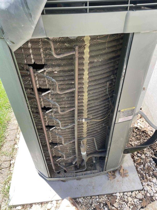 Completed comprehensive cooling system tune-up on outdoor AC unit located in backyard. Upon inspection, condenser coils showed heavy accumulation of dirt, dust, and debris throughout both coil banks, significantly restricting airflow and reducing system efficiency. Performed thorough coil cleaning to restore proper heat transfer capability. Inspected electrical components including capacitor and contactor, verified all wire connections were secure, and confirmed system operational status. Unit returned to proper working condition with improved airflow and cooling performance.