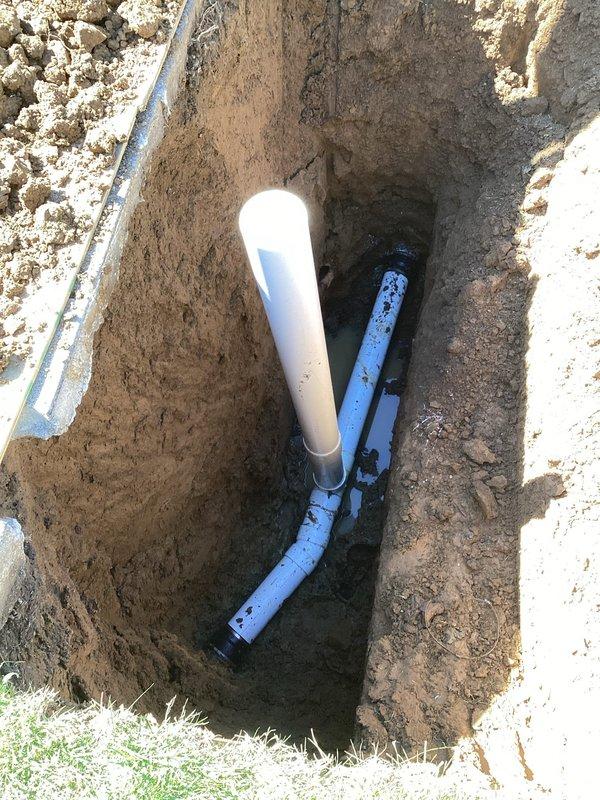 Completed sewer lateral repair under City of Overland permit PSL26-0028, permit # PP26-0228. Excavated trench to access existing sewer line, installed new PVC piping with proper fittings and connections to restore functionality. Work included removal of damaged sections, placement of replacement white and gray PVC pipes with appropriate couplings, and proper alignment to ensure code-compliant drainage flow. All installations positioned below grade level per municipal requirements.