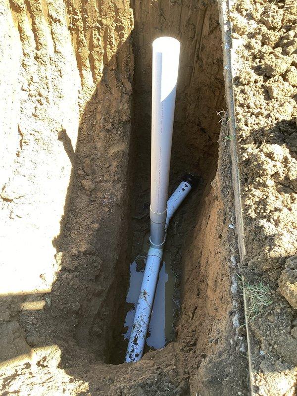 Completed sewer lateral repair under City of Overland permit PSL26-0028, permit # PP26-0228. Excavated trench to access existing sewer line, installed new PVC piping with proper fittings and connections to restore functionality. Work included removal of damaged sections, placement of replacement white and gray PVC pipes with appropriate couplings, and proper alignment to ensure code-compliant drainage flow. All installations positioned below grade level per municipal requirements.