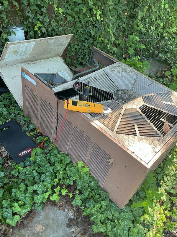 Responded to no-cooling complaint on residential outdoor unit over 10 years old. Upon arrival, found unit blowing warm air as reported. Performed diagnostic testing with multimeter on condenser components to identify system failure. Accessed internal components by removing top panels and tested electrical systems and refrigerant circuit. Unit showed signs of age-related wear and required repair to restore cooling function.