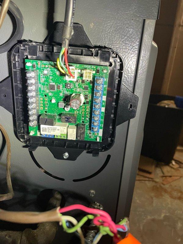 Responded to no-cool call on recently installed residential air conditioning system with thermostat power loss issue. Upon arrival, inspected thermostat wiring and traced low-voltage circuit back to outdoor condensing unit control board. Found loose wire connections at control board terminal blocks and improperly secured low-voltage wiring causing intermittent power loss to thermostat. Removed control board cover, inspected circuit board for damage, and identified multiple wire connections requiring proper termination. Re-landed all low-voltage wiring to appropriate terminals on control board, secured connections at blue terminal blocks, and verified proper wire routing through conduit. Tested thermostat power with multimeter and confirmed stable 24VAC supply. Reinstalled control board cover, cycled system through complete cooling operation, and verified thermostat maintained power throughout multiple on/off cycles. System operating normally with no further power interruptions detected