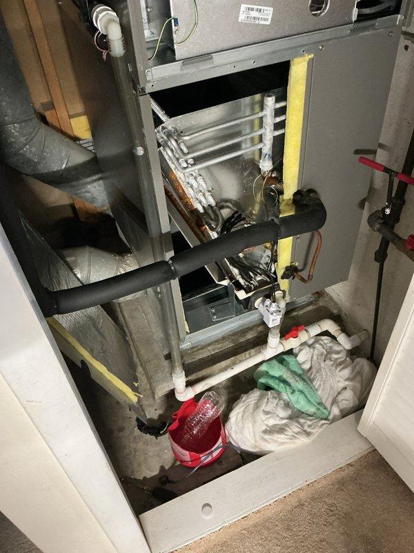 Responded to report of water leaking inside HVAC unit located in utility closet. Upon inspection, found active condensate drainage issue at evaporator coil assembly. Identified clogged condensate drain line causing water to overflow from drain pan. Cleared blockage from PVC condensate line and verified proper drainage flow. Replaced heavily soiled air filters which were restricting airflow and contributing to excessive condensation. Cleaned drain pan and tested system operation to confirm leak resolved and proper condensate removal restored.