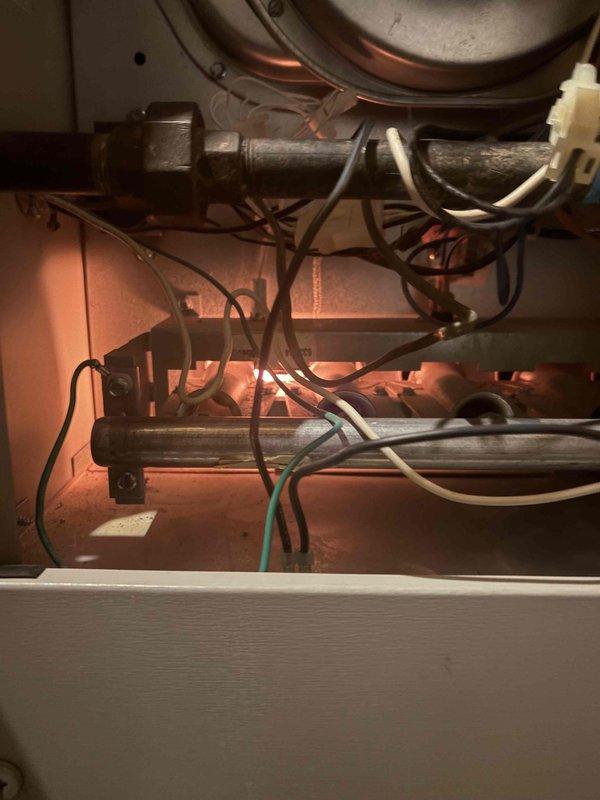 Responded to service call for furnace with blower motor activating prematurely upon system startup. Arrived at property after 3pm per customer request and provided 30-minute advance notice. Accessed basement unit (10+ years old) and performed diagnostic inspection of internal mechanical and electrical components. Examined gas valve assembly, electrical connections, control wiring, and blower motor circuitry. Identified loose electrical connectors and inspected thermostat control circuit for potential wiring issues causing premature blower activation. Documented internal component conditions including gas valve, wiring harnesses, and electrical junction points through photographic evidence for service records.