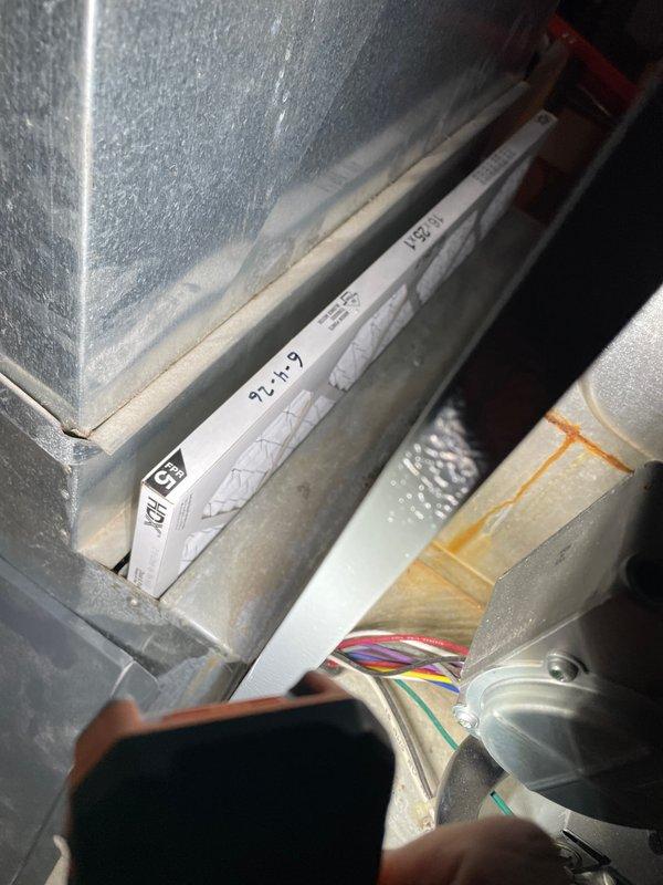 # HVAC Cooling Maintenance Service Completed

Performed comprehensive cooling maintenance tune-up on a 15-year-old residential air conditioning system. Conducted thorough inspection of air handler cabinet, including examination of condensate drainage pan, electrical connections, and internal components. Verified proper operation of blower motor assembly and associated wiring harnesses. 

Inspected ductwork connections and component installations within the system cabinet. Assessed condition of insulation materials and metal enclosure surfaces for signs of wear or deterioration. Documented existing dust and debris accumulation in condensate pan area. Verified all electrical connections were secure, with multi-colored wire bundles properly routed and terminated.

System confirmed operational at time of service. All standard preventive maintenance procedures completed per manufacturer specifications. Customer confirmed system was functioning properly prior to and following maintenance vis