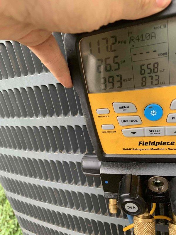 Completed comprehensive cooling system tune-up and maintenance on 15-year-old air conditioning unit. Performed refrigerant pressure analysis using digital manifold gauge, recording superheat at 26.5°F and system pressures at 117.2 psig, confirming proper refrigerant charge and system operation. Inspected condenser coil fins, finding them in clean condition with good airflow capacity, and verified heat exchanger components showing normal wear patterns consistent with system age. System tested and confirmed operational with all parameters within manufacturer specifications.