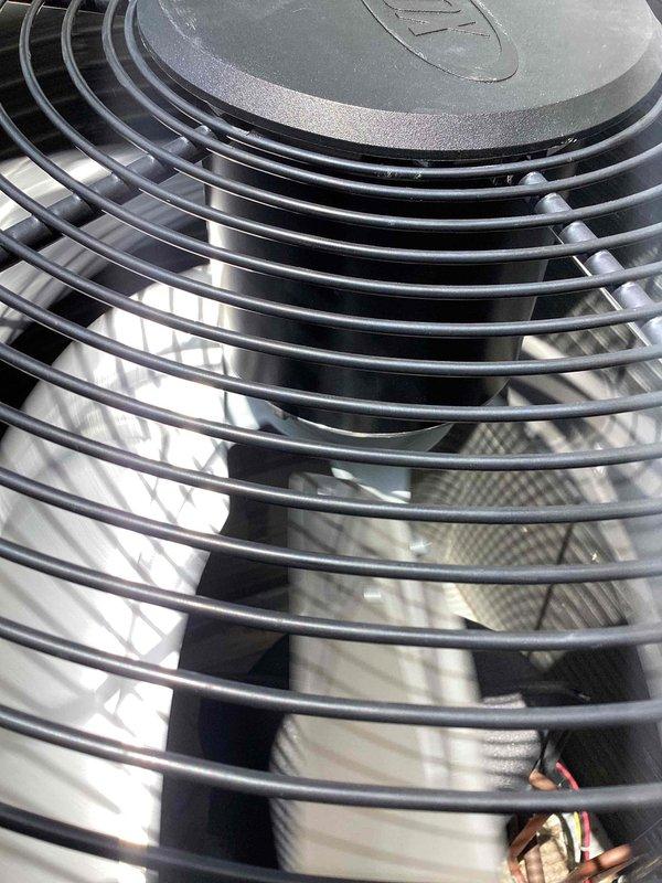 Replaced defective condenser fan motor and fan blade on outdoor HVAC unit. Unit was tested after repair and confirmed operational for both heating and cooling functions. Old components were removed and discarded per warranty protocol.