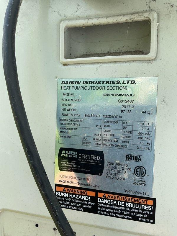 # HVAC Service Completed

Responded to no cooling complaint on 9-year-old Daikin mini-split system (Model RX18NMVJU) located in garage. Upon inspection, found unit utilizing R410A refrigerant with factory charge of 2.49 lbs. Connected service gauges to access ports and evaluated system performance. Documented equipment specifications and current operating condition through detailed photographic documentation of outdoor unit nameplate and service port connections. Unit showed signs of age-related wear with visible surface discoloration and weathering on exterior panels and mounting hardware.