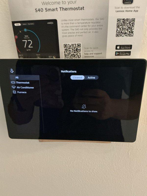 Responded to callback for humidity and cooling issues on newly installed system. Inspected Lennox S40 smart thermostat operation and verified system notifications were cleared with no active alerts. Examined air return grille and noted dust accumulation on louvers that could restrict airflow and impact system performance; recommended cleaning to optimize air circulation and system efficiency.