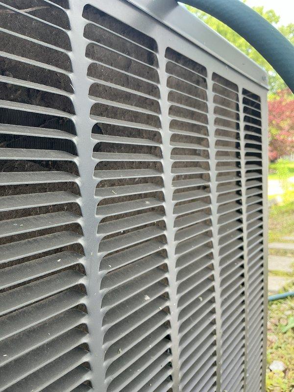 Completed comprehensive AC tune-up on 12-year-old residential split system located at ground level. Performed full system inspection including condenser unit cleaning, coil evaluation, electrical connection testing, and blower assembly assessment. Condenser grille showed moderate debris accumulation which was addressed during service, and all internal components including capacitor, control board, and wiring connections were inspected and found operational.