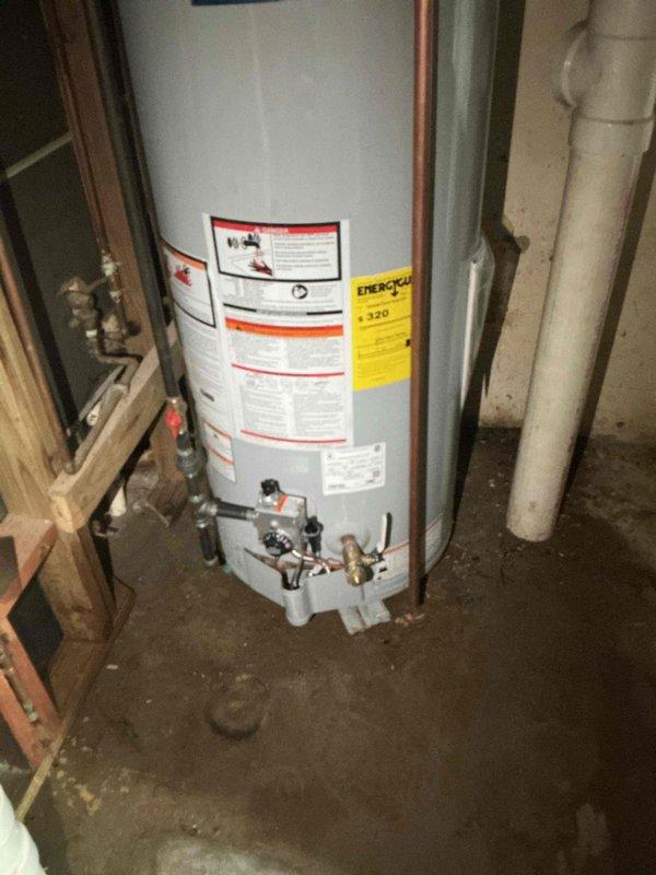 Responded to no hot water complaint in basement. Removed and replaced existing failed water heater with new 50-gallon gas tall unit. Installed all required plumbing connections including hot and cold water lines with brass shut-off valves, pressure relief valve with proper discharge piping, and gas line connections. Mounted thermal expansion tank to wall with secure strapping. Connected exhaust venting system to ensure proper combustion air flow and safety compliance. Applied plumbing identification sticker and verified all connections for leaks. Tested unit operation and confirmed proper ignition, heating function, and temperature settings. System restored to full operational status with adequate hot water supply.