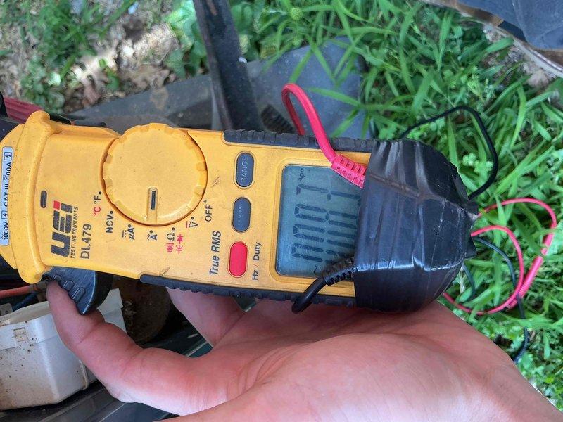 Completed comprehensive cooling system tune-up on 13-year-old air conditioning unit located in backyard. Performed standard maintenance procedures including inspection and cleaning of blower wheel assembly, which showed typical dust accumulation for unit age. Verified electrical performance using clamp meter to measure voltage and amperage, confirming system is operating within manufacturer specifications.