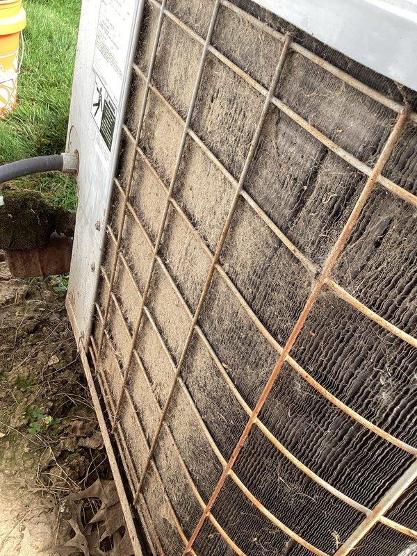 Responded to no cooling complaint on 2013 residential AC unit unable to maintain 74-degree setpoint. Upon inspection, found evaporator coil heavily clogged with dirt and debris causing restricted airflow and reduced cooling capacity. Removed and cleaned coil, inspected capacitor and electrical connections which appeared functional, and restored system to proper operation with adequate cooling performance.