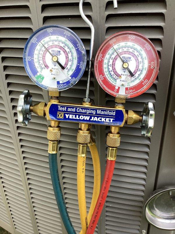 Responded to callback for frozen evaporator coil on outdoor unit 10. Upon arrival, confirmed coil was previously frosted over and unit had been shut off with fan running to facilitate defrost. Accessed electrical panel and inspected contactor, wiring connections, and control components for proper operation. Connected manifold gauge set to refrigerant lines and verified system pressures and charge levels. All electrical connections secure, refrigerant charge within specification, and system operating normally after defrost cycle completed. Photographed electrical panel configuration and gauge readings for documentation.