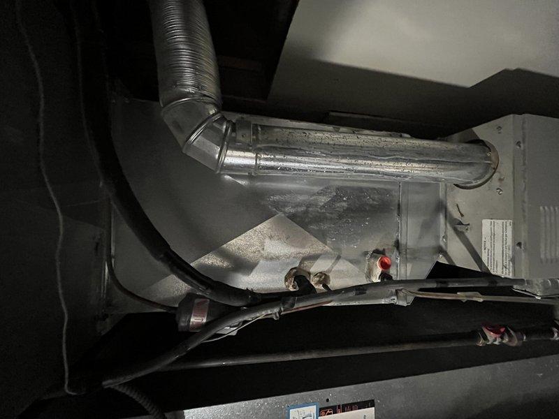 Responded to no cooling complaint on 20-year-old air conditioning system located in back area near basement furnace. Upon inspection, found severely clogged air filter restricting airflow and excessive condensation on evaporator coil assembly. Replaced dirty air filter and addressed moisture accumulation issues affecting system performance. System restored to proper cooling operation.