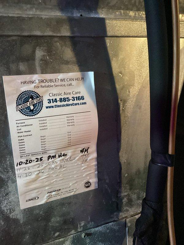 Responded to callback for AC unit icing over. Inspected attic-mounted air handler and verified airflow restrictions causing coil freeze-up. Documented equipment condition and existing service history sticker showing previous maintenance dates, then checked ductwork, refrigerant lines, and insulation integrity in attic space to identify root cause of icing issue.