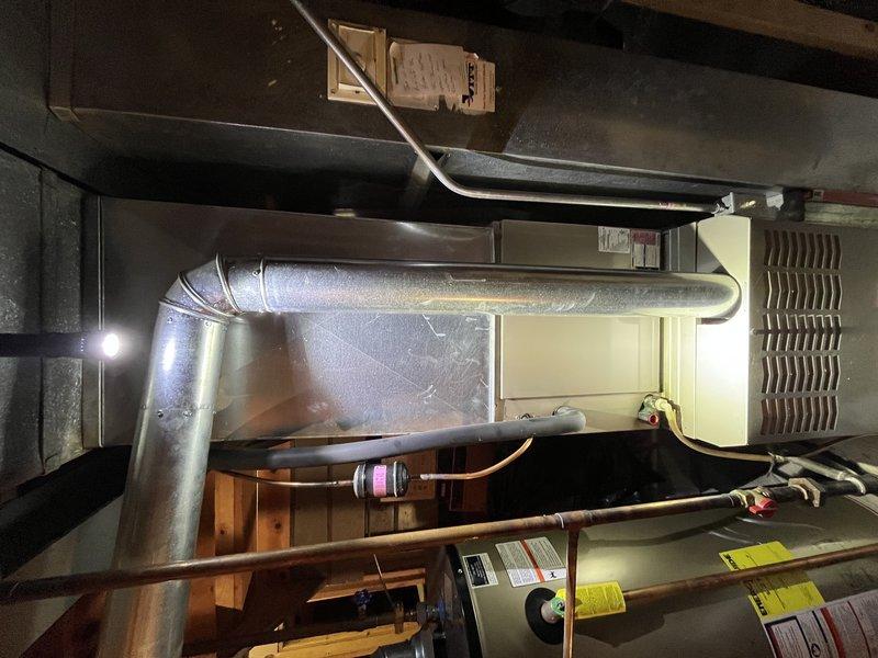 Responded to no cooling complaint on basement HVAC unit. Upon inspection, discovered severely corroded evaporator coil with extensive oxidation on copper tubing, indicating refrigerant leak and system degradation. Unit was blowing air but unable to maintain temperature due to compromised heat exchange capacity from deteriorated coil condition. Documented equipment condition with photos showing advanced corrosion throughout coil assembly and aging system components requiring replacement.