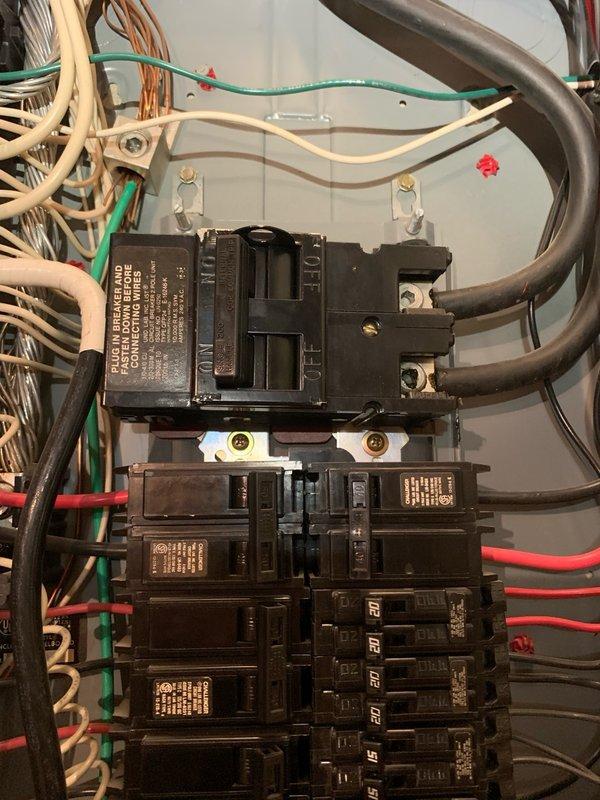 Performed consultation and site assessment for whole home surge protection installation. Evaluated existing electrical service including Milbank meter enclosure with Gridstream RF smart meter and main electrical panel configuration. Inspected panel containing main breaker assembly, multiple single-pole and double-pole branch circuit breakers rated at various amperage levels, and existing wiring infrastructure consisting of mixed-age conductors including cloth-wrapped legacy wiring and modern color-coded branch circuits. Documented current electrical service setup including conduit connections, grounding system, and available panel capacity to determine optimal surge protection device specifications and installation requirements for whole home surge suppression system.