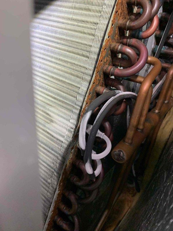 Responded to no cooling complaint on 10-year-old Lennox air conditioning system. Upon inspection, discovered severely corroded evaporator coil with significant oxidation on copper refrigerant tubes and rust deterioration along coil casing edges. The extensive corrosion on the coil assembly and connecting components indicated long-term moisture exposure and end-of-service-life condition. Documented coil condition with photographs showing advanced deterioration of copper tubing, aluminum fins, and mounting brackets. Advised customer that evaporator coil replacement is necessary to restore cooling function, as the current coil's compromised integrity is preventing proper heat exchange and refrigerant flow.