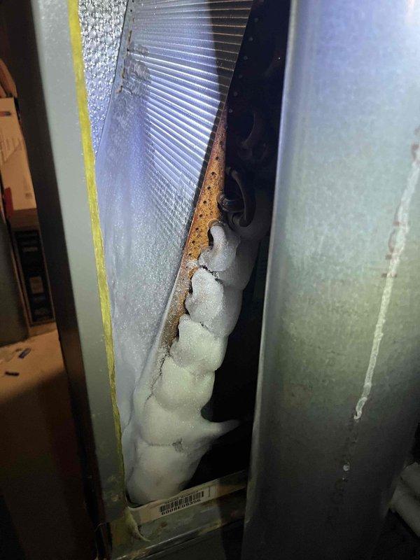 Responded to no cooling complaint on main floor Lennox air conditioning system. Upon inspection, discovered evaporator coil had severe foam insulation failure with material expanding and protruding from the air handler cabinet, causing significant airflow restriction. The deteriorated insulation was blocking airflow across the coil, preventing proper heat exchange and resulting in loss of cooling capacity. Documented conditions with photographs showing foam material extruding from coil assembly and overall system configuration. Advised customer of findings and provided options for repair, including evaporator coil replacement and proper resealing of air handler cabinet to restore system efficiency and cooling performance.