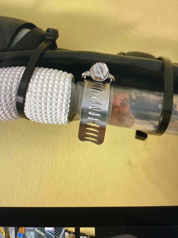 Responded to recall for condensate drain line leak caused during previous maintenance visit. Inspected condensate drainage system and identified improperly secured connection between flexible drain hose and rigid drain pipe. Reinstalled and properly secured condensate line connections using appropriate hose clamps, ensuring watertight seal at all junction points. Verified condensate drainage system functioning correctly with no leaks present. System tested and returned to normal operation.