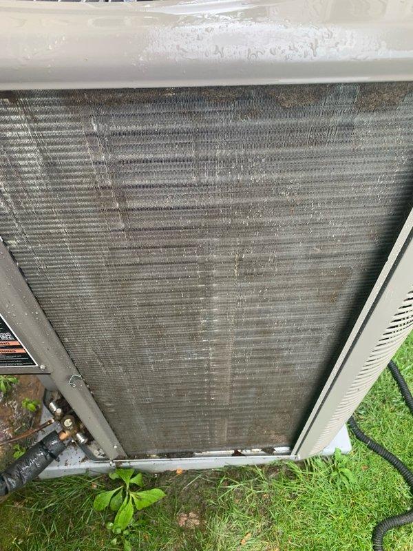 Completed comprehensive cooling system tune-up on 1.5-year-old AC unit located in side yard. Performed full system inspection, cleaned heavily soiled condenser coil that showed significant accumulation of dust and debris between fins affecting heat transfer efficiency, checked refrigerant levels, tested electrical components, and verified proper system operation. All components functioning within normal parameters upon completion, with improved airflow through condenser after cleaning.