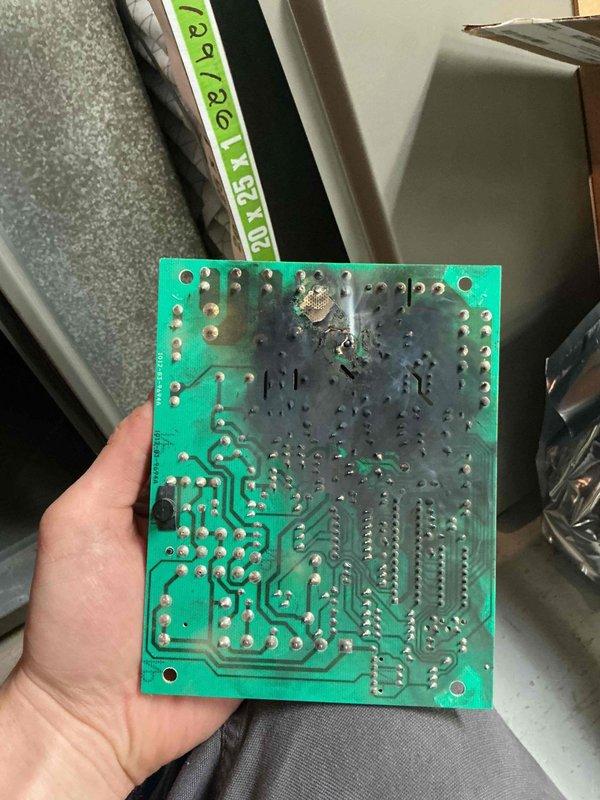 Responded to emergency no-cooling call after customer had been without air conditioning for four days. Diagnosed failed control board with visible heat damage and burn marks on circuit board, causing complete system failure. Replaced defective control board with new unit sourced from Lennox Earth City. Removed and disposed of damaged board showing extensive thermal damage and charring around component mounting area. Restored system to normal operation and verified proper cooling function before departure.