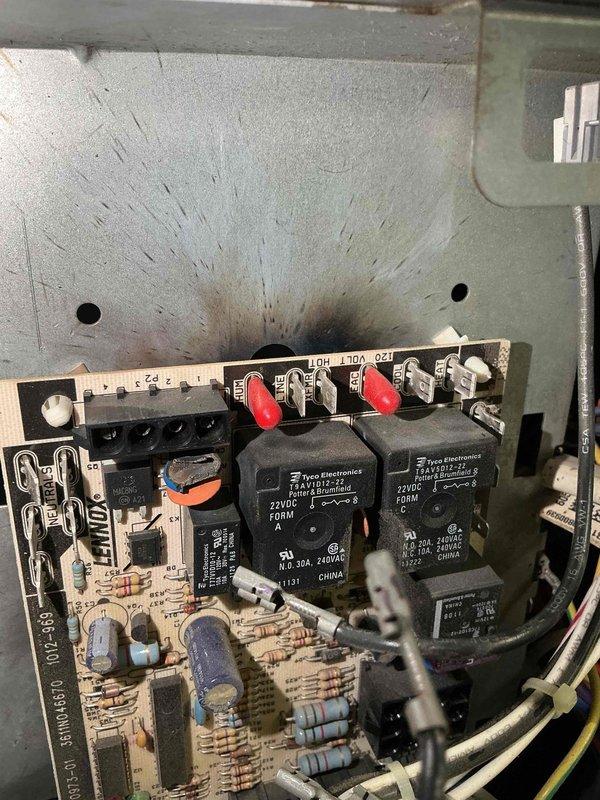 Responded to emergency no-cooling call after customer had been without air conditioning for four days. Diagnosed failed control board with visible heat damage and burn marks on circuit board, causing complete system failure. Replaced defective control board with new unit sourced from Lennox Earth City. Removed and disposed of damaged board showing extensive thermal damage and charring around component mounting area. Restored system to normal operation and verified proper cooling function before departure.