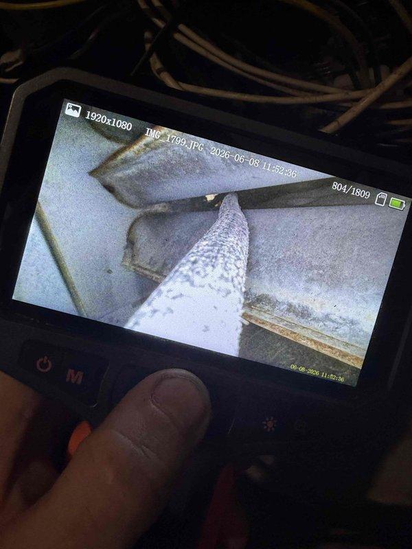 Responded to no-cool call for 33-year-old outdoor unit with reported blower malfunction. Upon arrival, performed visual inspection and utilized digital borescope to examine internal ductwork and blower assembly components, documenting interior conditions showing dust accumulation on metallic duct surfaces and foil-wrapped ductwork. Unit had been shut off prior to service as previously advised.