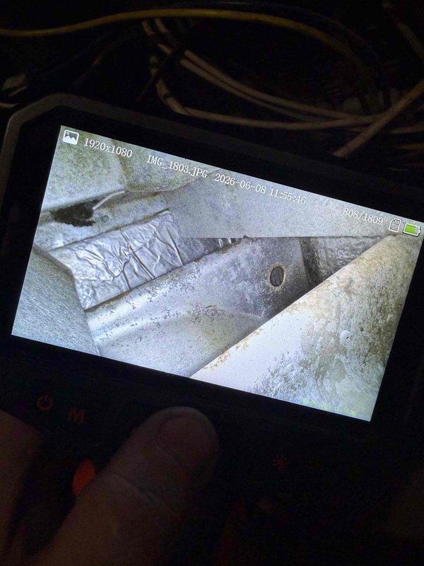 Responded to no-cool call for 33-year-old outdoor unit with reported blower malfunction. Upon arrival, performed visual inspection and utilized digital borescope to examine internal ductwork and blower assembly components, documenting interior conditions showing dust accumulation on metallic duct surfaces and foil-wrapped ductwork. Unit had been shut off prior to service as previously advised.