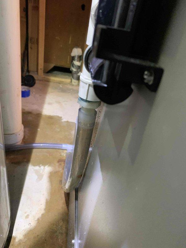 Responded to reported humidifier leak in basement. Upon arrival, found significant water pooling around base of HVAC unit and evidence of ongoing water discharge onto concrete floor. Inspected humidifier system and associated drainage components, identifying failed or disconnected drain line as source of water accumulation. Observed water damage and staining on floor surface indicating prolonged moisture exposure. Repaired drainage issue, secured all connections, and verified proper water flow through condensate system. Tested humidifier operation to confirm leak was resolved and unit was functioning correctly without further water discharge.