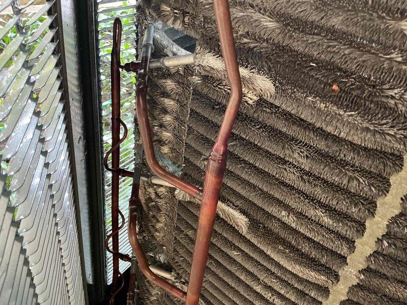 Completed comprehensive cooling tune-up on 6-year-old ground-level AC unit located in basement. Performed standard diagnostic testing using digital multimeter to verify electrical components and system operation. Discovered evaporator coil heavily fouled with accumulated dust, dirt, and debris significantly restricting airflow and reducing system efficiency. Thoroughly cleaned evaporator coil, removing thick buildup from fins and restoring proper air passage. Inspected refrigerant lines and connections for leaks or damage. Verified all electrical connections secure and within manufacturer specifications. System restored to optimal operating condition with improved airflow and cooling capacity. Renewed preventive maintenance agreement on-site.