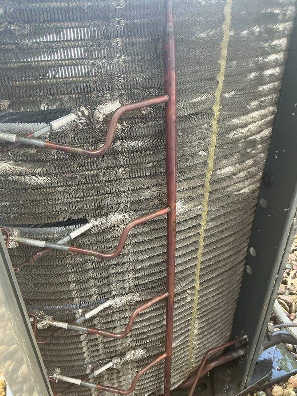 Responded to no cooling complaint at residential property. Upon inspection, found outdoor condenser coil heavily contaminated with dirt, dust, and debris accumulation, significantly restricting airflow through the unit. Performed thorough coil cleaning to restore proper heat exchange function and system operation.