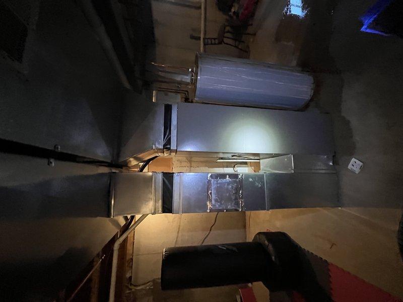 Responded to service call for loud noise coming from downstairs when AC system was running. Inspected 21-year-old Lennox outdoor condenser unit and interior air handler/ductwork in basement. Upon examination, identified noise source originating from indoor HVAC components. Performed diagnostic evaluation of both outdoor condensing unit and indoor air handling equipment to isolate mechanical issue causing excessive operational noise during cooling cycle.