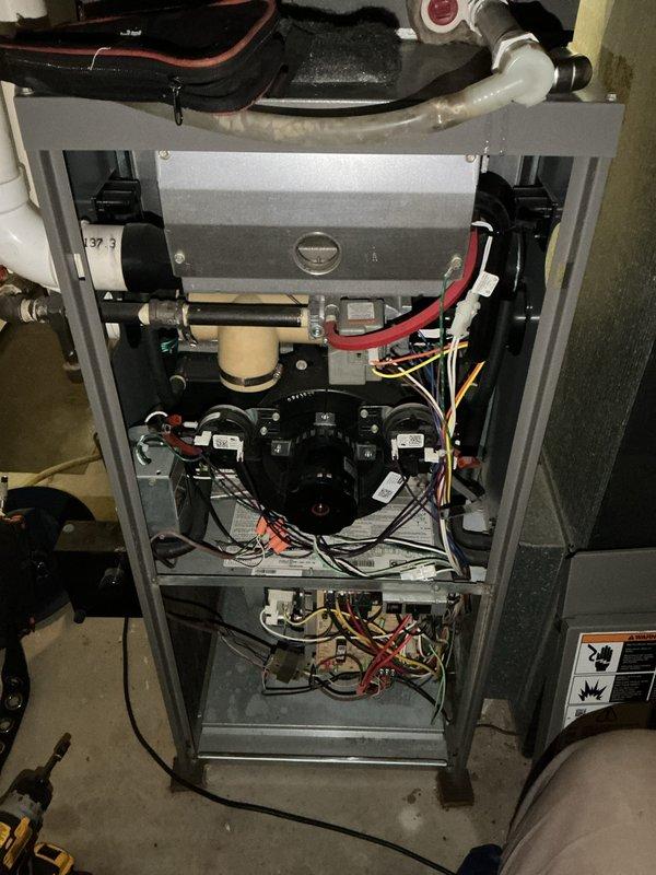 Completed comprehensive Supertune maintenance service on residential HVAC system consisting of one outdoor condensing unit and one indoor furnace unit located in basement. Performed thorough inspection, cleaning, and testing of both components to ensure optimal system performance and efficiency. Outdoor condenser unit showed signs of age and weathering with accumulated dirt and debris on exterior panels and coils; cleaned and serviced unit accordingly. Indoor furnace unit inspected with front panel removed, revealing dual blower motors, copper refrigerant lines, PVC condensate drain, control boards, and electrical connections all functioning properly. All system components tested and confirmed operational within manufacturer specifications.