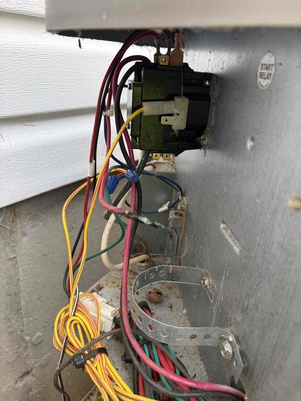 Responded to no cooling call on 10+ year old outdoor unit located on side of home. Upon inspection, found severely corroded dual-run capacitor with visible rust, oxidation, and deteriorated terminals affecting system operation. Diagnosed failed capacitor as cause of no cooling condition. Removed and replaced defective capacitor with new component. Tested system operation and verified proper cooling function restored. Unit operating within normal parameters at time of departure.