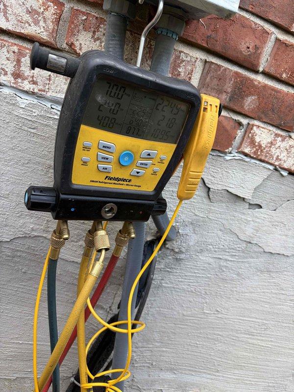 # HVAC Service Call - No Cooling Condition

Responded to a no cooling complaint on a residential property with two AC units. The non-operational unit was over ten years old and readily accessible at ground level, requiring no ladder work for service access.

Upon arrival, performed complete system diagnostics using manifold gauges and digital testing equipment to assess refrigerant pressures, temperatures, and overall system performance. Initial inspection revealed the affected unit was not providing adequate cooling to the designated zone.

Conducted thorough examination of the outdoor condensing unit, checking electrical connections, contactor operation, and compressor function. Verified proper voltage supply and amperage draw on all major components. Inspected the condenser coil for airflow restrictions, debris buildup, or damage that could impair heat rejection capacity.

Evaluated the evaporator coil assembly, which showed typical wear patterns consistent with a unit of this age. 
