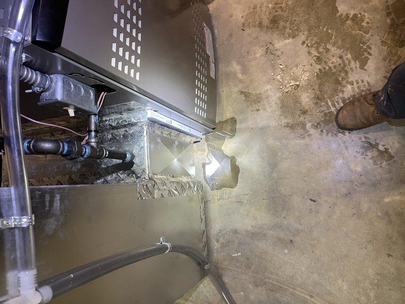Responded to callback for 4-month-old system experiencing water leakage in basement. Upon inspection, identified compromised condensate drainage system with debris accumulation affecting proper water evacuation. Cleared condensate line obstruction, verified drain pan integrity, and confirmed proper pitch on drainage components. Inspected refrigerant lines and evaporator coil assembly for any secondary moisture sources. System tested and operating within manufacturer specifications with no further water discharge observed at floor level.