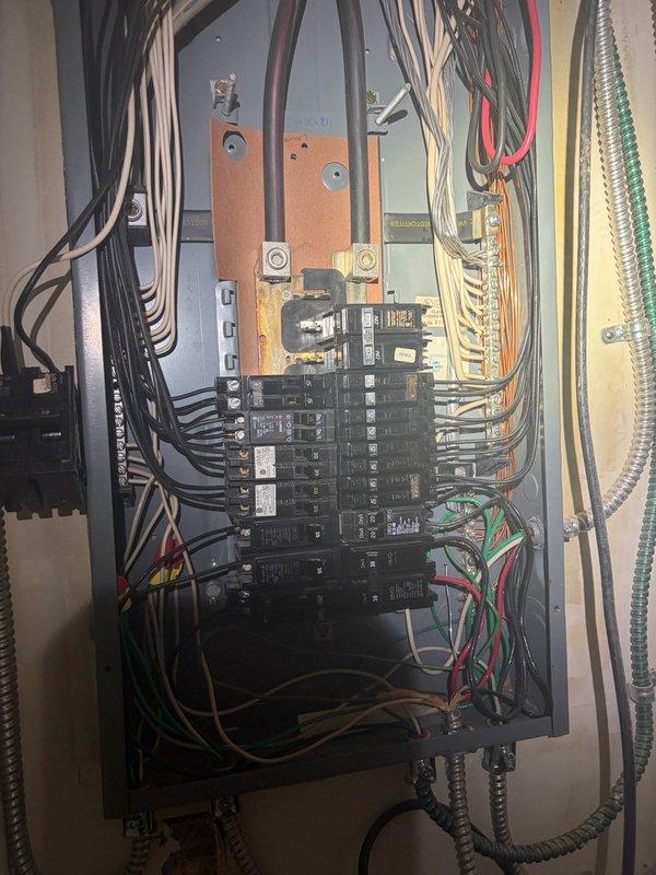 Completed comprehensive electrical system inspection of residential property. Evaluated main service panel with main disconnect and branch circuit protection, as well as secondary distribution panel containing multiple circuit breakers with copper bus bars. Both panels showed proper wire routing through metallic conduit and appropriate color-coded conductors. All components were photographed and assessed for code compliance and safe operation.