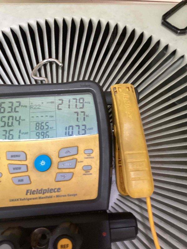 Responded to no-cool emergency service call for aging air conditioning system with non-operational outdoor unit. Upon arrival, performed comprehensive diagnostic testing using digital manifold gauges to assess refrigerant pressures, temperatures, and system performance across the condenser coil and heat exchanger components. Measurements revealed abnormal pressure readings and temperature differentials indicating potential compressor failure or electrical control issues preventing outdoor unit from engaging. Documented system conditions with detailed photos of diagnostic equipment readings showing operating temperatures and pressures at various test points on the condenser unit to establish baseline system performance data for repair recommendations.
