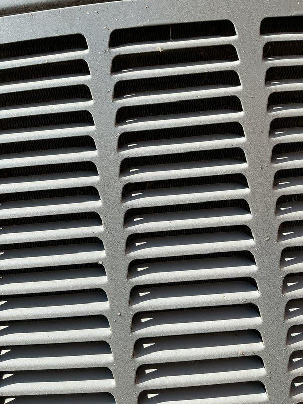 Completed preventive seasonal cooling checkup on 4-year-old single outdoor condensing unit located in backyard. Performed comprehensive U10 cooling tune-up protocol including inspection of blower motor assembly, electrical connections, and ventilation components. All colored wiring connections verified secure, airflow pathways confirmed unobstructed through louvered grille system, and unit interior inspected for proper operation with standard dust accumulation noted for equipment age.