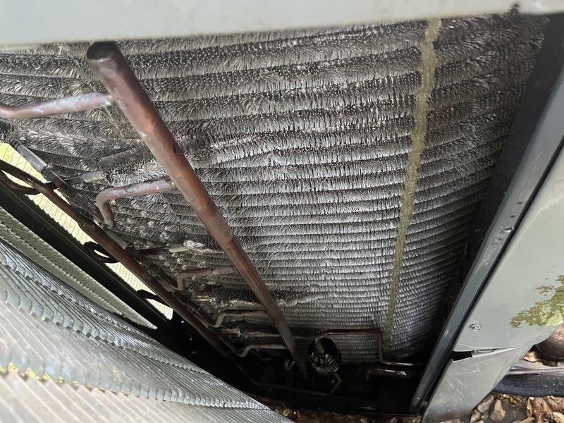 Completed comprehensive cooling maintenance tune-up on 10-year-old Trane system. Inspected evaporator coil and found heavy accumulation of dust, lint, and debris restricting airflow through fins. Cleaned coil assembly thoroughly to restore proper heat exchange efficiency. Verified refrigerant lines and connections for integrity. Tested system operation and confirmed unit cooling properly with temperature readings at 225°F. System returned to full operational status.