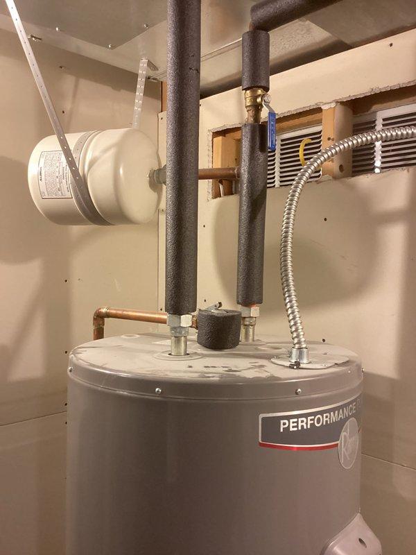Replaced existing water heater with new 50-gallon electric tall residential unit in basement location. Installation included mounting new tank, connecting insulated hot and cold water lines with proper copper piping, and installing 3/4" pressure reducing valve (PRV) with shutoff valve on incoming water supply. Verified all connections for proper operation, ensured thermal expansion accommodation, and confirmed unit functionality upon completion.