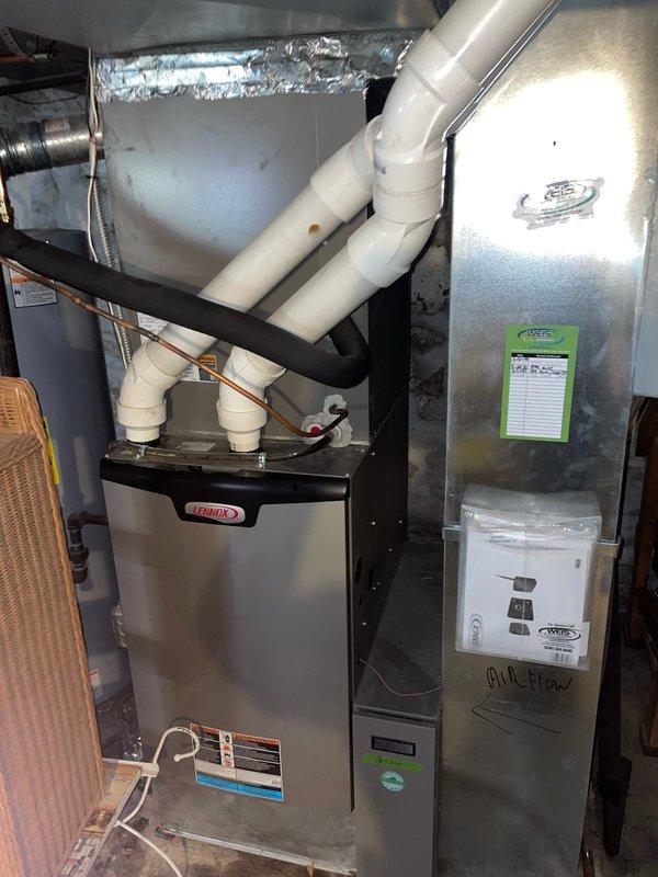 Responded to callback for frozen AC unit that was not cooling properly. Upon arrival, inspected indoor air handler and evaporator coil system in basement utility area, confirming previous freeze-up condition had resolved. Verified proper airflow through ductwork, checked humidifier operation on main supply duct, and ensured all condensate drainage lines were clear and functioning correctly. System operating normally at time of inspection with no current freeze conditions observed.