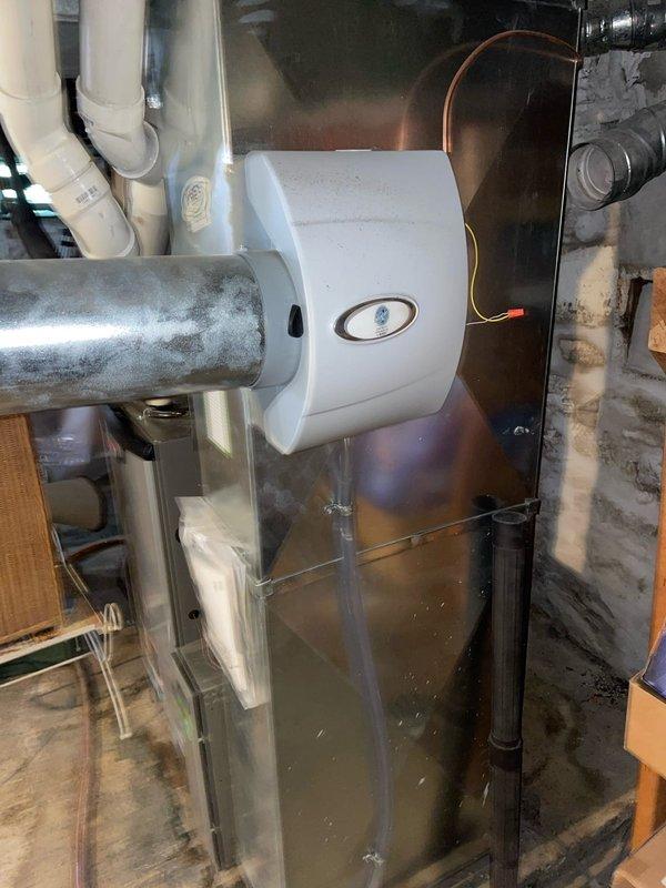 Responded to callback for frozen AC unit that was not cooling properly. Upon arrival, inspected indoor air handler and evaporator coil system in basement utility area, confirming previous freeze-up condition had resolved. Verified proper airflow through ductwork, checked humidifier operation on main supply duct, and ensured all condensate drainage lines were clear and functioning correctly. System operating normally at time of inspection with no current freeze conditions observed.