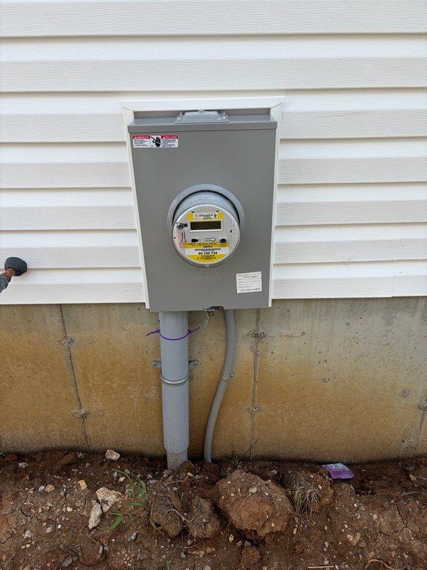 Responded to request for installation of electrical outlets in basement area. Upon arrival, assessed existing electrical infrastructure and determined optimal routing for new circuits. Installed three GFCI-protected duplex receptacles in basement, running appropriate gauge NM cable from main electrical panel through studs and joists to outlet locations. Verified proper grounding at each receptacle box, tested circuit integrity with multimeter, and confirmed GFCI functionality. All work completed to current NEC standards with proper wire securing and box mounting. Exterior meter installation photographed for documentation showing main service entrance, meter base, and conduit runs in satisfactory condition.