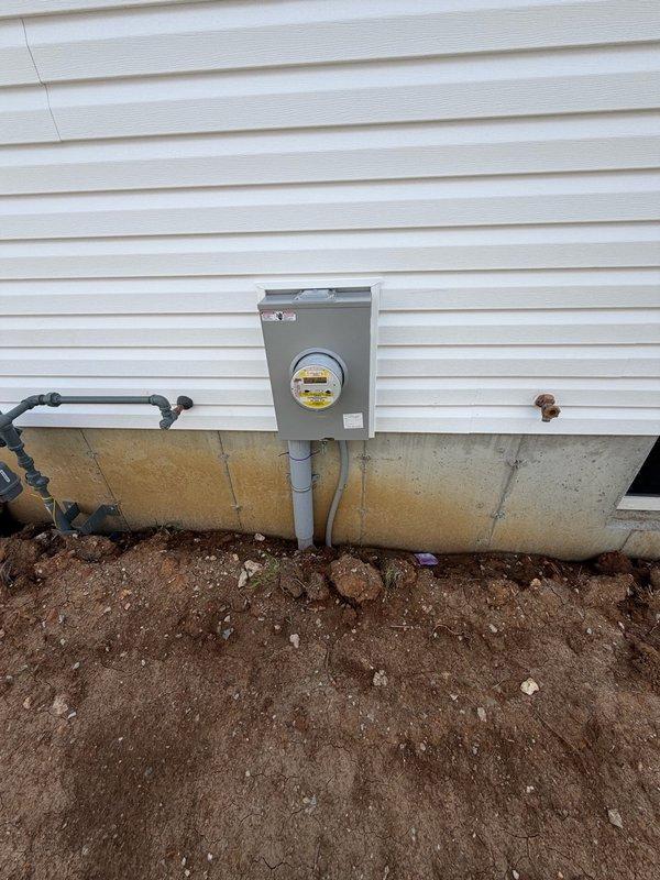 Responded to request for installation of electrical outlets in basement area. Upon arrival, assessed existing electrical infrastructure and determined optimal routing for new circuits. Installed three GFCI-protected duplex receptacles in basement, running appropriate gauge NM cable from main electrical panel through studs and joists to outlet locations. Verified proper grounding at each receptacle box, tested circuit integrity with multimeter, and confirmed GFCI functionality. All work completed to current NEC standards with proper wire securing and box mounting. Exterior meter installation photographed for documentation showing main service entrance, meter base, and conduit runs in satisfactory condition.